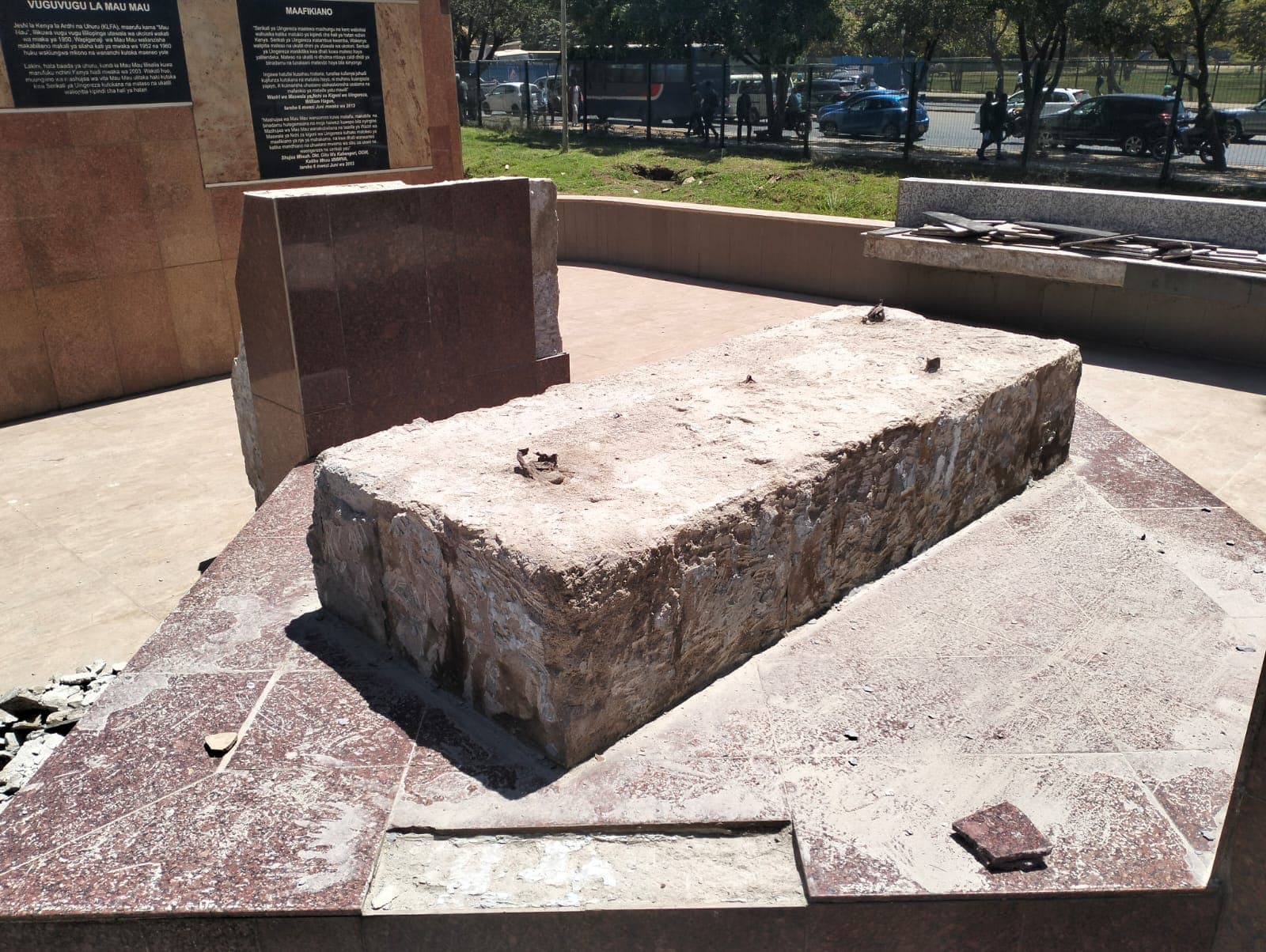 The monument's central rough-stone feature on its granite plinth, mid-restoration