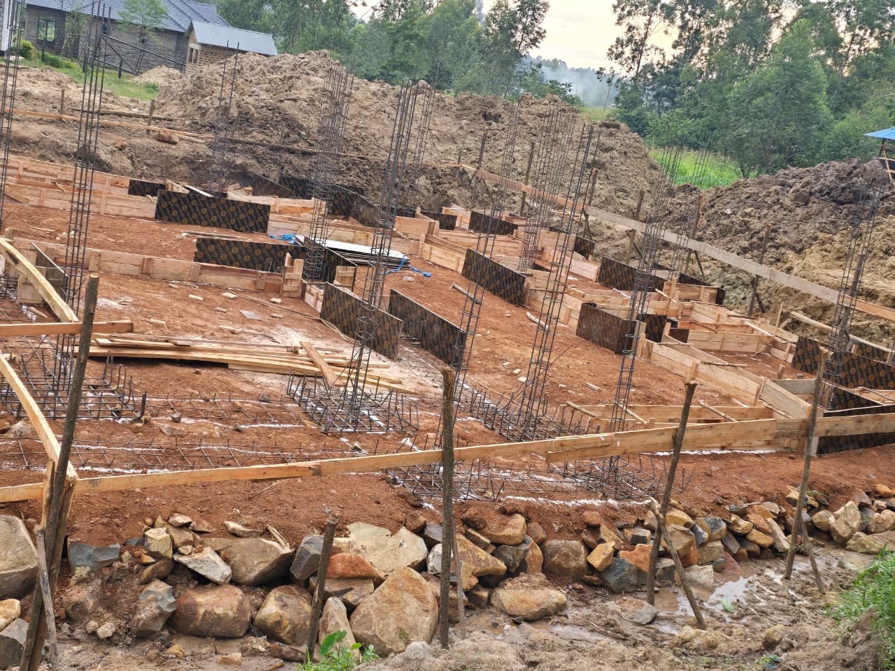 Stepped foundations and formwork set out across the sloping site
