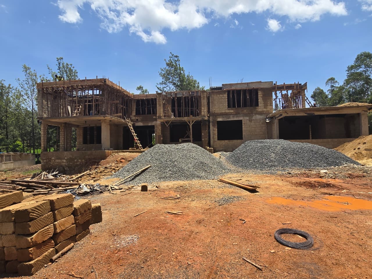 The structure continuing to the upper floors, with aggregate staged on site
